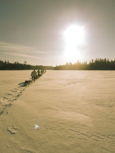 Snowshoers Walk into the Sunrise